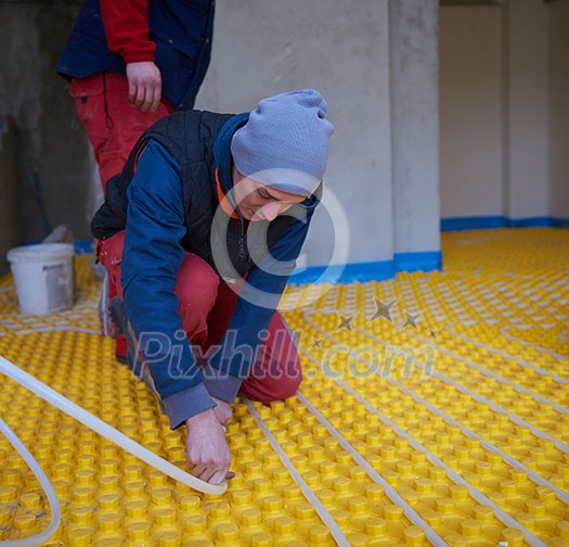 grouo of workera installing underfloor heating and colling in modern home grouo of workera installing underfloor heating and colling in modern home