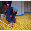 grouo of workera installing underfloor heating and colling in modern home