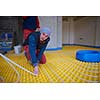 grouo of workera installing underfloor heating and colling in modern home