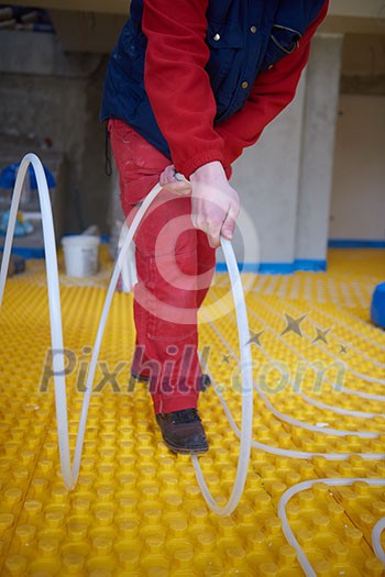 grouo of workera installing underfloor heating and colling in modern home grouo of workera installing underfloor heating and colling in modern home