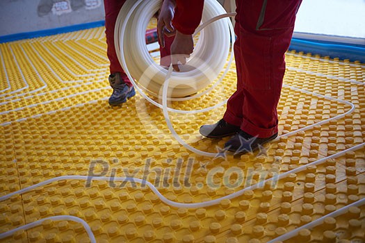 grouo of workera installing underfloor heating and colling in modern home grouo of workera installing underfloor heating and colling in modern home