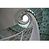 modern glass spiral staircase with metallic hand-rails.