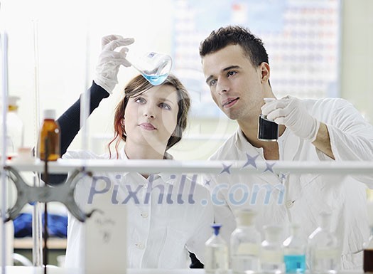 young students couple making test in bright labaratory young students couple making test in bright labaratory