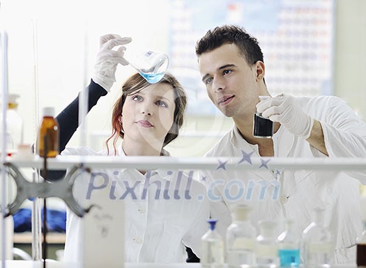 young students couple making test in bright labaratory