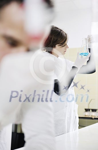 young students couple making test in bright labaratory young students couple making test in bright labaratory