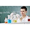 young man scientist in chemistry bright lab