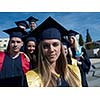 young graduates students group  standing in front of university building on graduation day