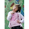 happy young girl posing and jumping with abstract urban style painting bacground begind