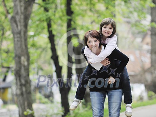 happy oung mother and daughter have fun outdoor 
