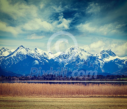 Vintage retro hipster style travel image of Bavarian Alps countryside lake landscape. Bavaria, Germany