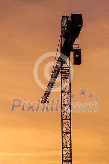 Building crane silhouette in sky on sunset. Munich, Germany