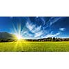 Panorama of German countryside and village on sunset with sun. Bavaria, Germany