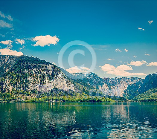 Vintage retro effect filtered hipster style travel image of castle at Hallstatter See mountain lake in Austria. Salzkammergut region, Austria