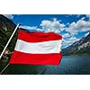 Austrian flag agains mountain lake and Austria alps background