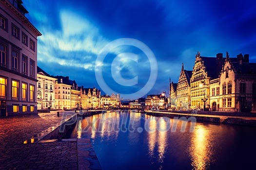 Vintage retro hipster style image of travel Europe Belgium background - Ghent canal, Graslei and Korenlei streets in twlight the evening. Ghent, Belgium