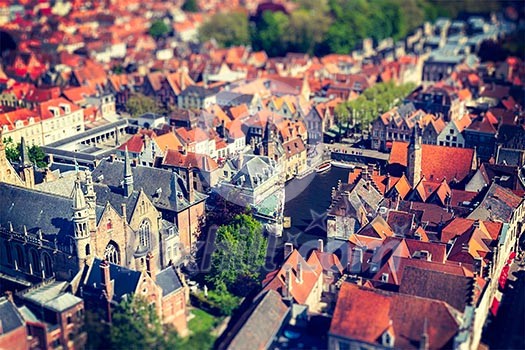 Aerial view of Bruges (Brugge) from Belfry, Belgium. Tilf shift effect. Cross processed vintage retro style.