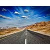 Travel forward concept background - road in Himalayas with mountains and dramatic clouds. Ladakh, Jammu and Kashmir, India