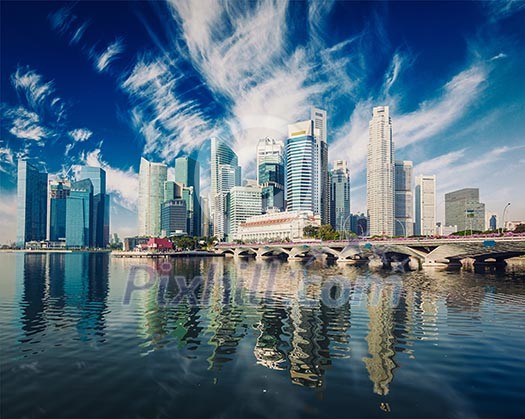 Vintage retro effect filtered hipster style image of Singapore business district skyscrapers skyline and Marina Bay in day