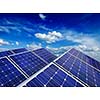 Solar power generation technology, alternative renewable energy and environment protection ecology concept  - close up of solar battery panels against blue sky with clouds