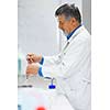 Senior male researcher carrying out scientific research in a lab (shallow DOF; color toned image)