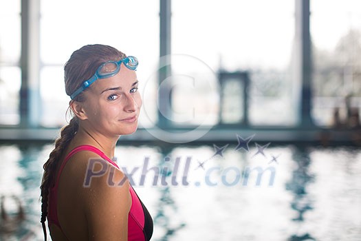 Female swimmer in an indoor swimming pool - going for her swim (shallow DOF) Female swimmer in an indoor swimming pool - going for her swim (shallow DOF)