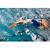 Female swimmer in an indoor swimming pool - doing crawl (shallow DOF)