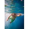 Underwater shot of male swimmer in green shorts