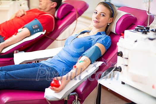 Young woman giving blood in a modern hospital Young woman giving blood in a modern hospital