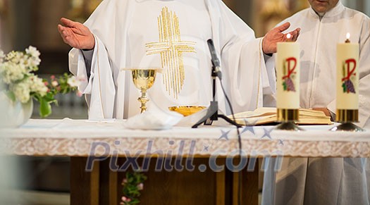 Priest during a wedding ceremony/nuptial mass Priest during a wedding ceremony/nuptial mass