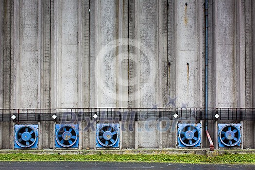 Conrete wall of a cereal silo tower with vents Conrete wall of a cereal silo tower with vents