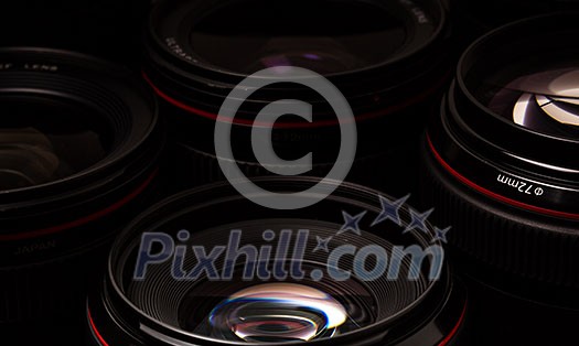 Modern camera lenses with reflections, low key image Modern camera lenses with reflections, low key image