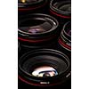 Modern camera lenses with reflections, low key image