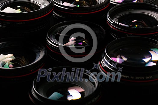Modern camera lenses with reflections, low key image Modern camera lenses with reflections, low key image