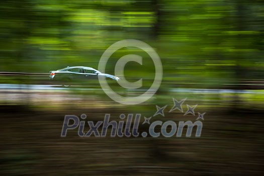 Car going fast on a hughway (motion blurred image)