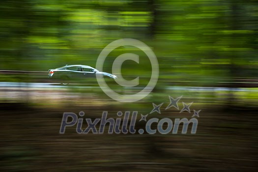Car going fast on a hughway (motion blurred image) Car going fast on a hughway (motion blurred image)