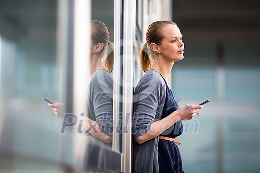 Portrait of a sleek young woman calling on a smartphone and using her laptop in a an
urban/city context (shallow DOF; color toned image) Portrait of a sleek young woman calling on a smartphone and using her laptop in a an
urban/city context (shallow DOF; color toned image)