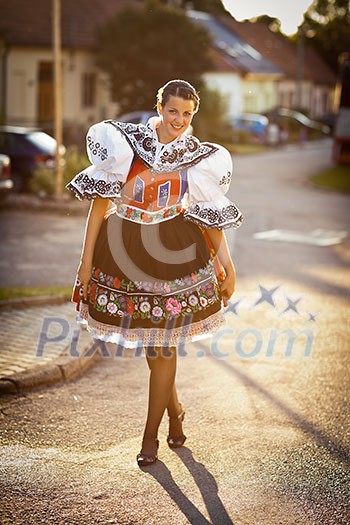 Keeping tradition alive: young woman in a richly decorated ceremonial folk dress/regional costume (Kyjov folk costume, Southern Moravia, Czech Republic)