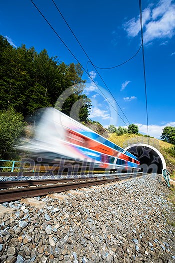Fast train passing through a tunnel on a lovely summer day (motion blurred image) Fast train passing through a tunnel on a lovely summer day (motion blurred image)