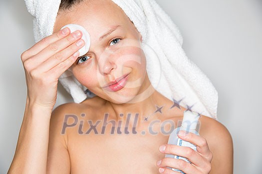 Beautiful brunette woman removing makeup from her face Beautiful brunette woman removing makeup from her face