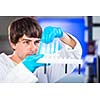 Young male researcher carrying out scientific research in a lab (shallow DOF; color toned image)