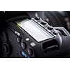 Professional modern DSLR camera - detail of the top LCD with settings - shutter speer, aperture, ISO, AF mode, battery info, RAW format indication,...