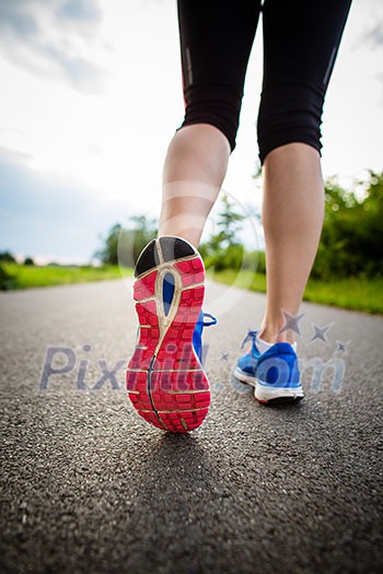 Young woman running outdoors on a lovely sunny winter/fall day