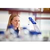 Portrait of a female researcher doing research in a lab (shallow DOF; color toned image)