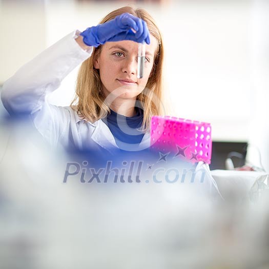 Portrait of a female researcher doing research in a lab (shallow DOF; color toned image)