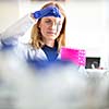 Portrait of a female researcher doing research in a lab (shallow DOF; color toned image)