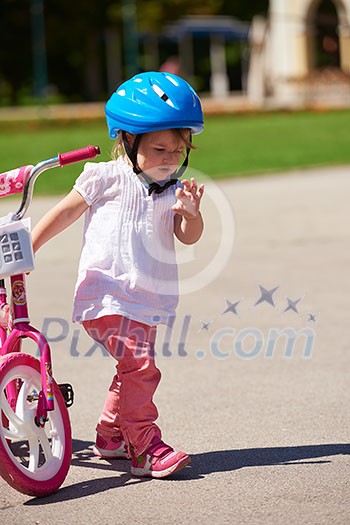 Happy childrens outdoor,  brother and sister in park have fun. Boy and girl in park learning to ride a bike.