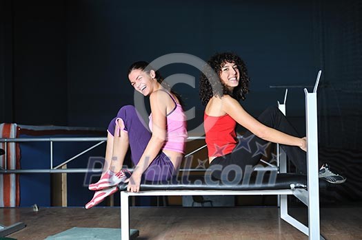 two women work out and streaching in fitness club two women work out and streaching in fitness club