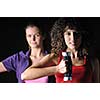 two girls working out with dumbbell in fitness club