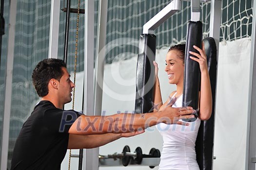 woman in the fitness gim working out with personal trainer coach woman in the fitness gim working out with personal trainer coach
