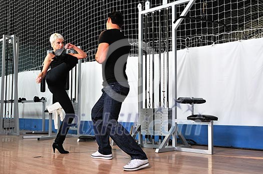 woman in the fitness gim working out with personal trainer coach woman in the fitness gim working out with personal trainer coach